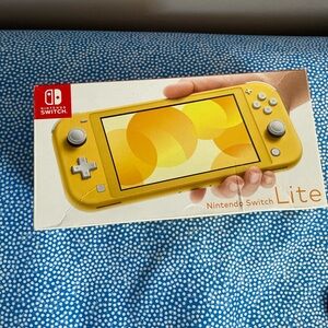 Selling Nintendo switch Lite New with Charger box and two games
